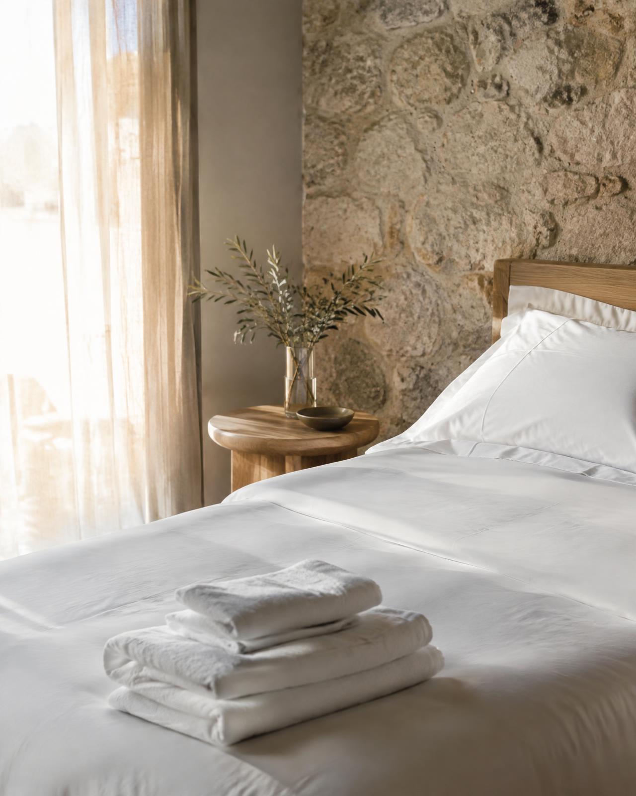 Freshly prepared guest bedroom with linen and towels
